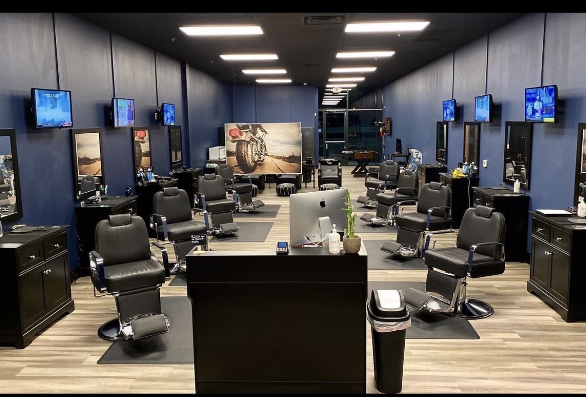 Inside Man Cave Salon — barber chairs, mirrors, and the lounge floor